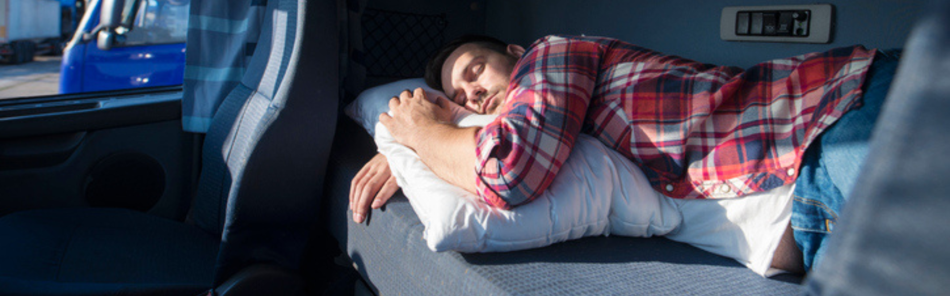 Man sleeping in semi truck cab