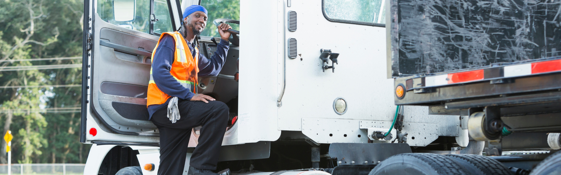 black man entering a semi truck cab