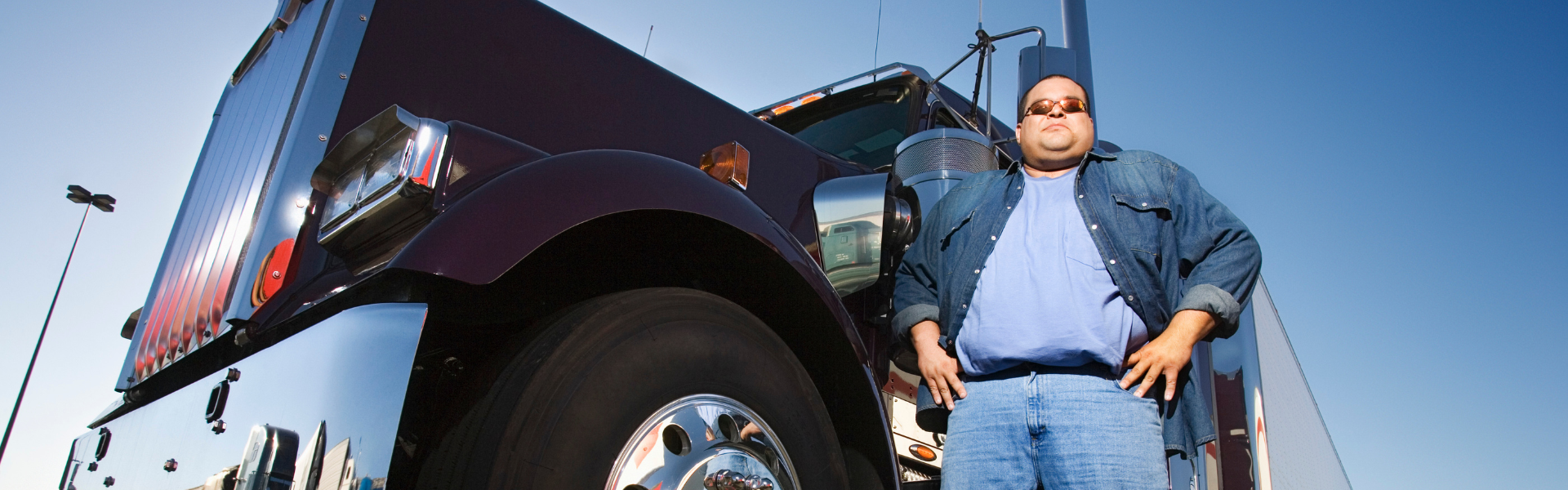 Man standing next to semi truck