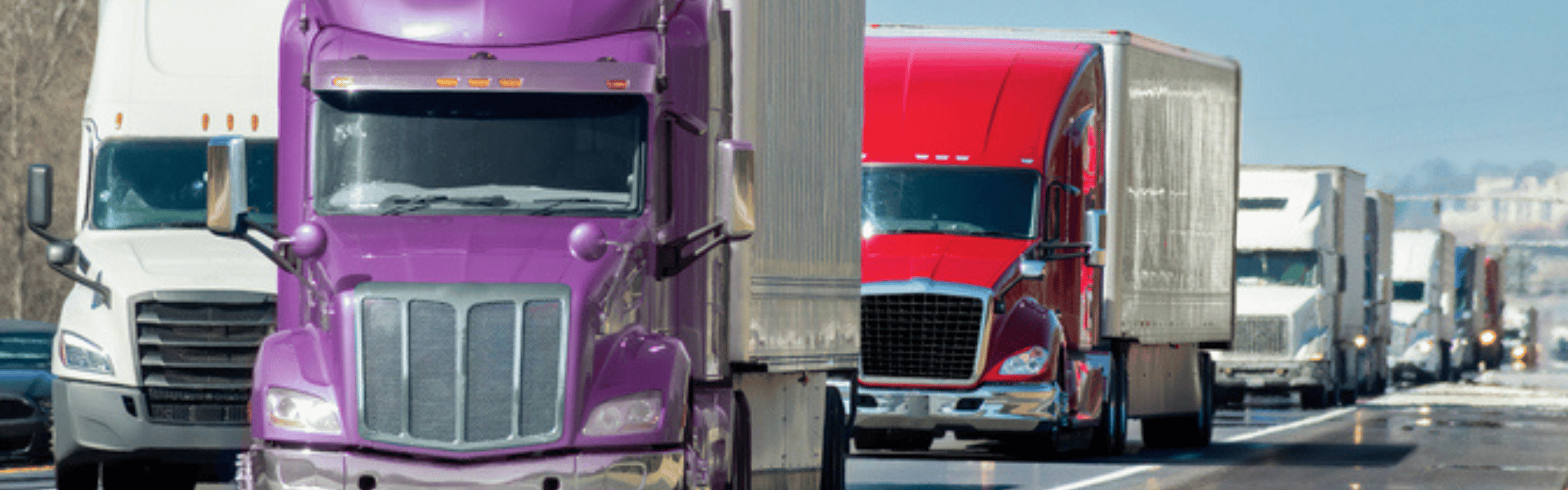 convoy of semi trucks on road