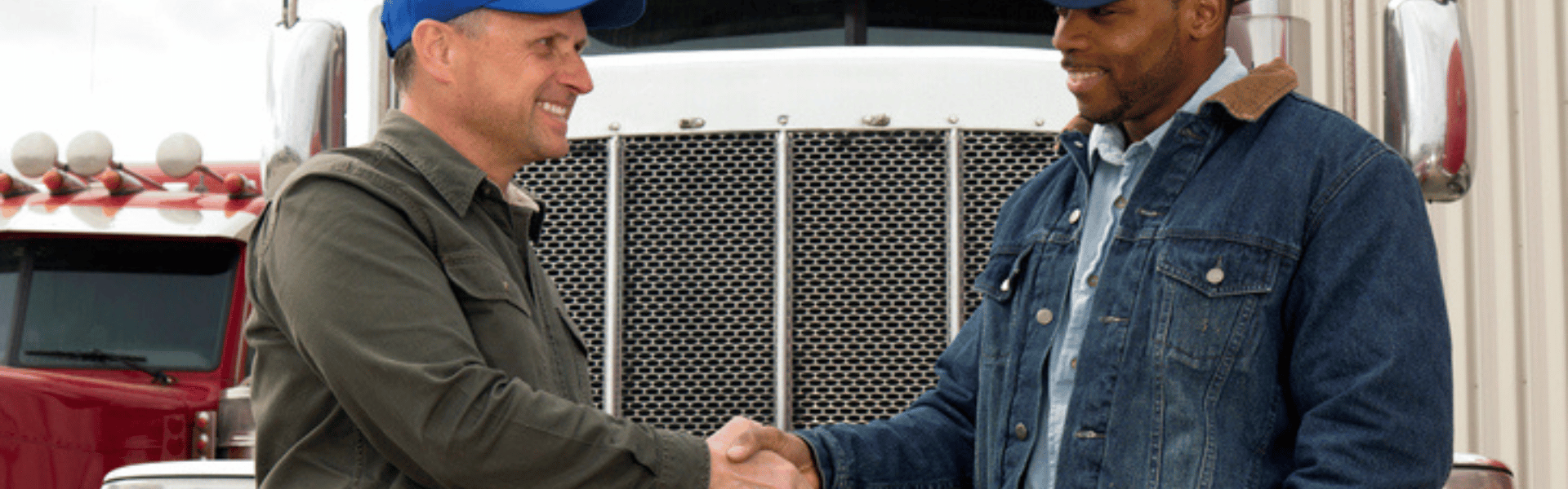 two men shaking hands in front of semi truck