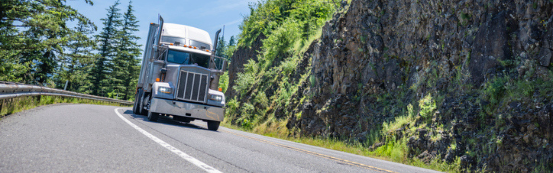semi truck driving on mountain road