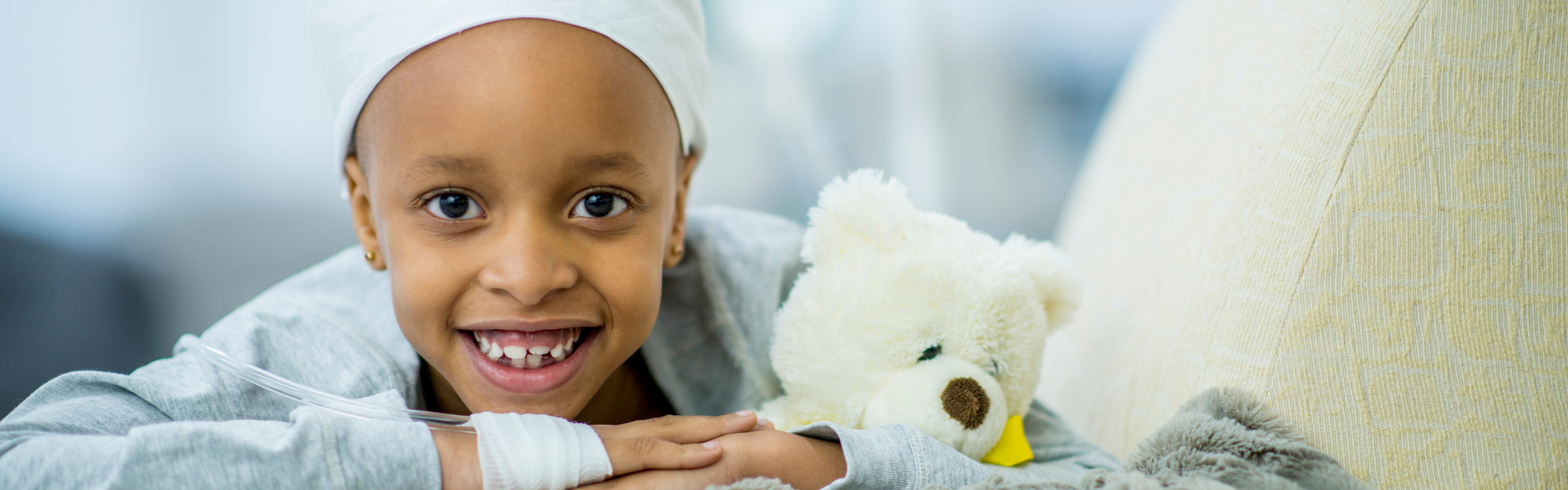child in cancer ward with teddy bear