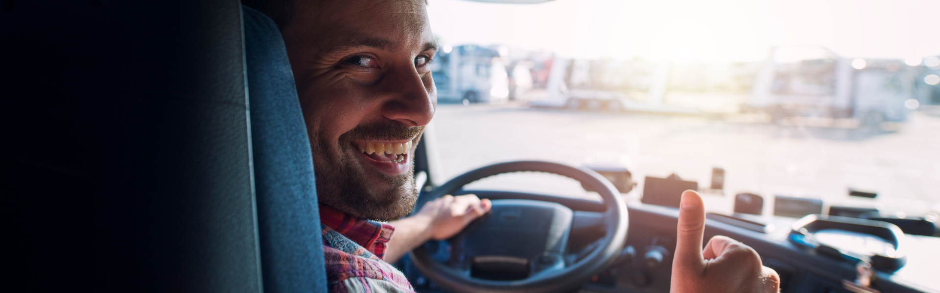 semi truck driver giving thumbs up
