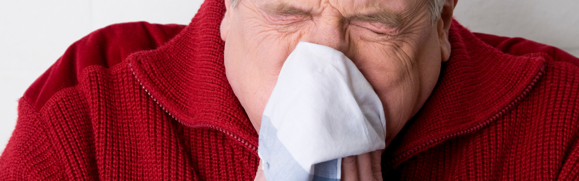man blowing nose