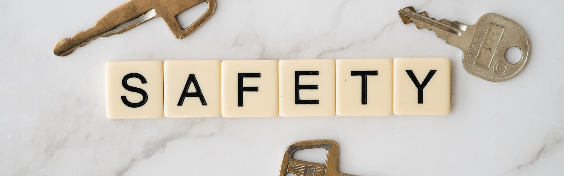 safety spelled out in scrabble letter with keys around it