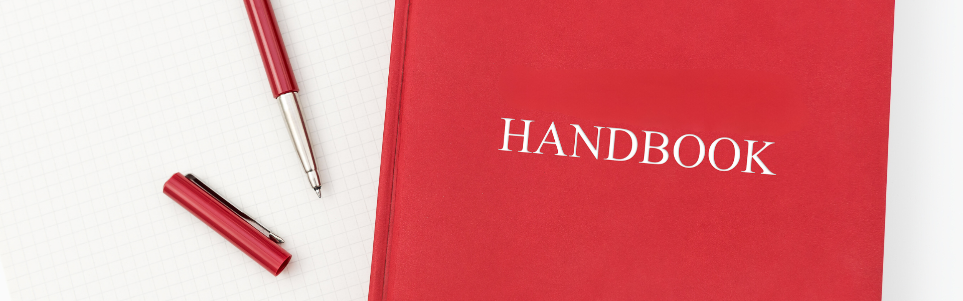 red handbook next to pen