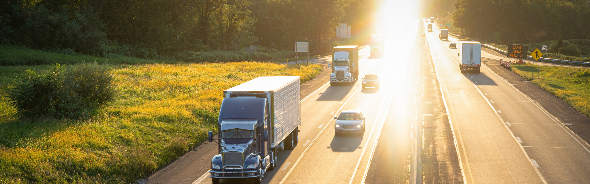 traffic on four lane highway at sunset