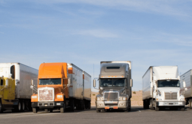 line of semi trucks parked