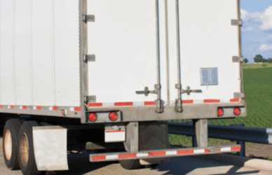 semi truck parked next to no parking sign