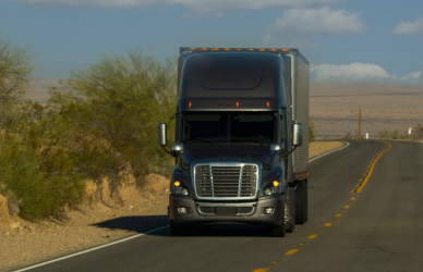 Gray semi truck on two lane road