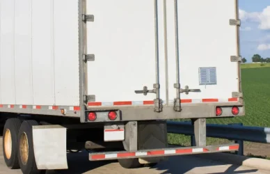 semi truck parked next to no parking sign
