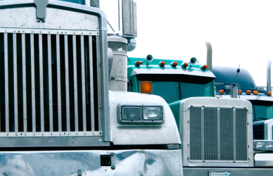 older semi trucks parked in a line