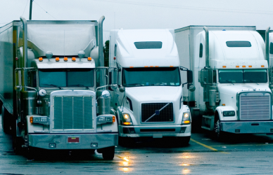 a variety of semi trucks parked in a row