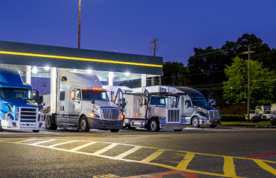 truck stop with well lit parking area and fuel canopies with semi trucks parked at fuel pumps safe truck stop for women