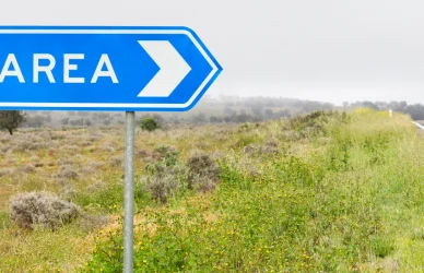 Roadside sign pointing toward a rest area