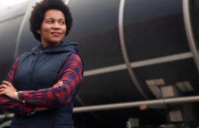 black woman standing near tanker semi truck