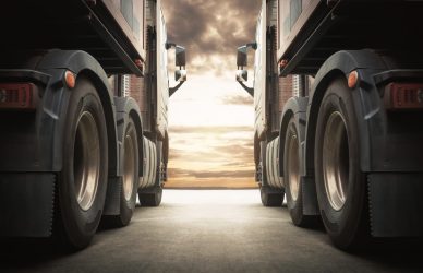 Semi TrailerTrucks on Parking with The Sunset Sky. Shipping Container Truck. Delivery Transit. Engine Diesel Truck Tractor. Industry Freight Trucks Logistics Cargo Transport.